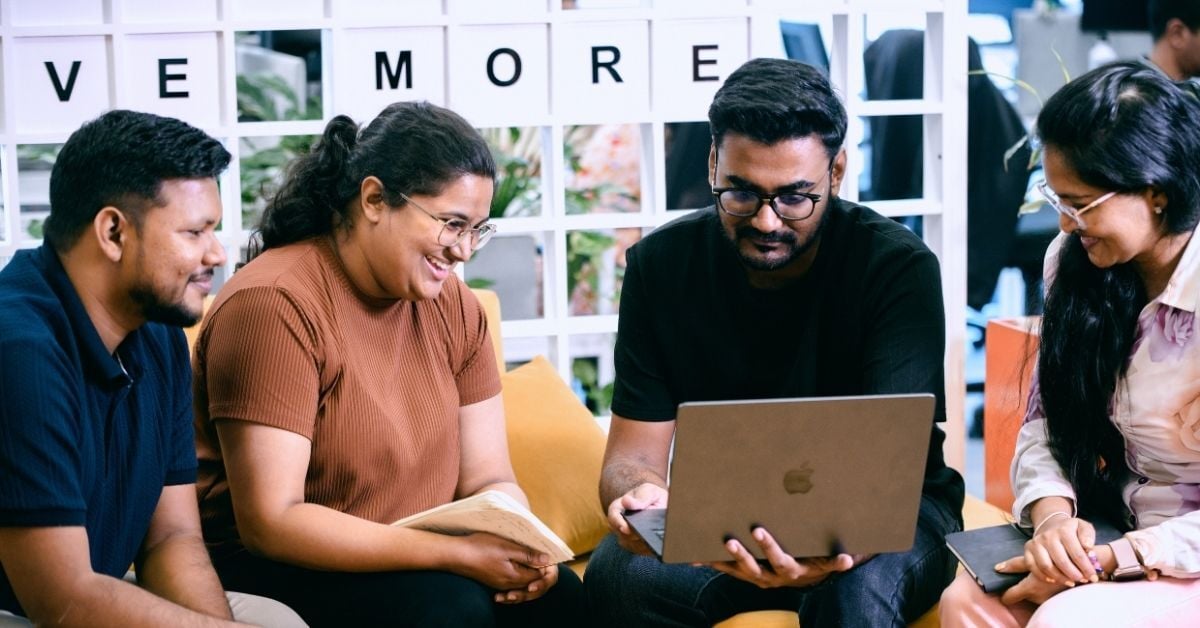 Dijital Team members working together on a laptop in the office in Sri Lanka